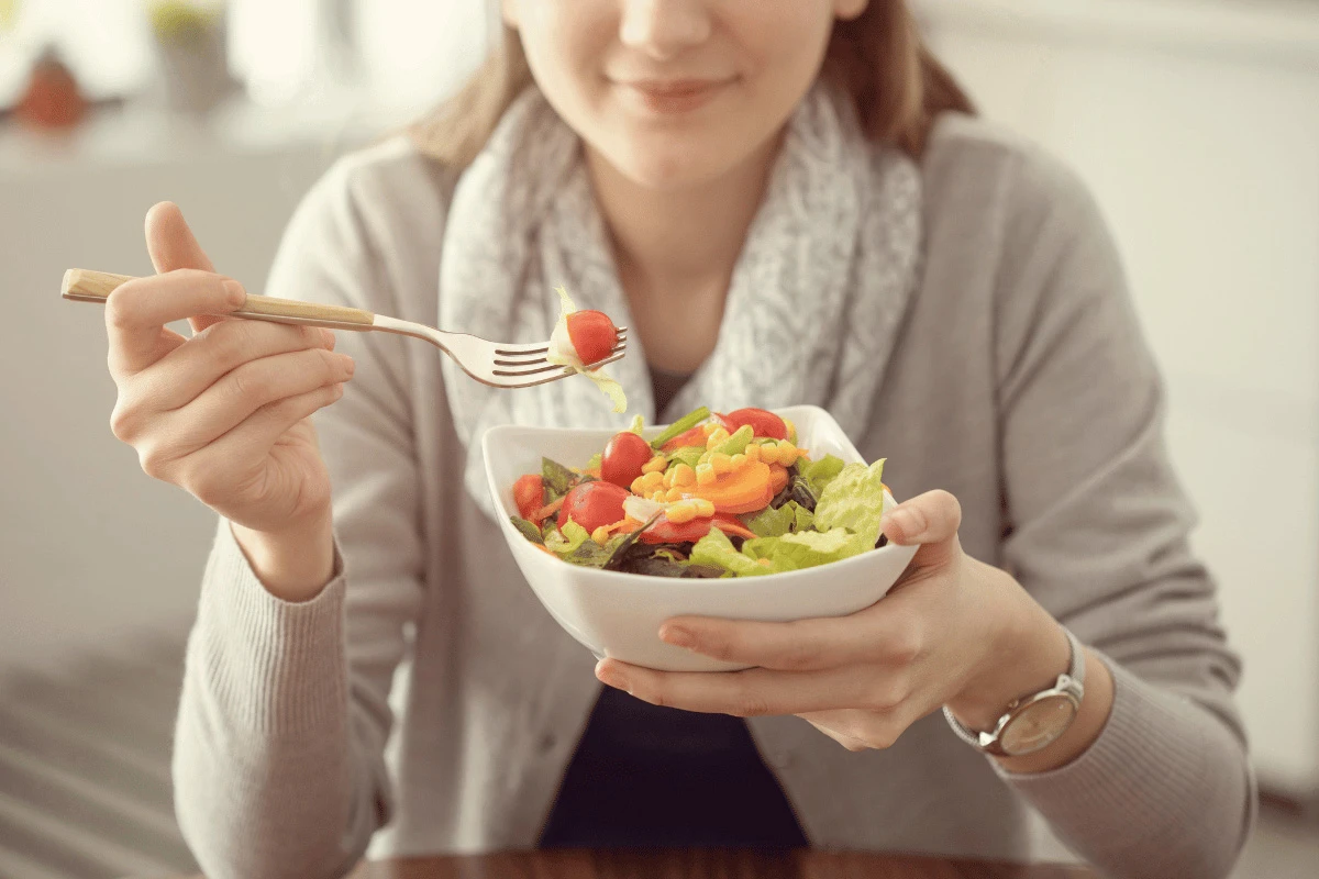 a woman eating a salad