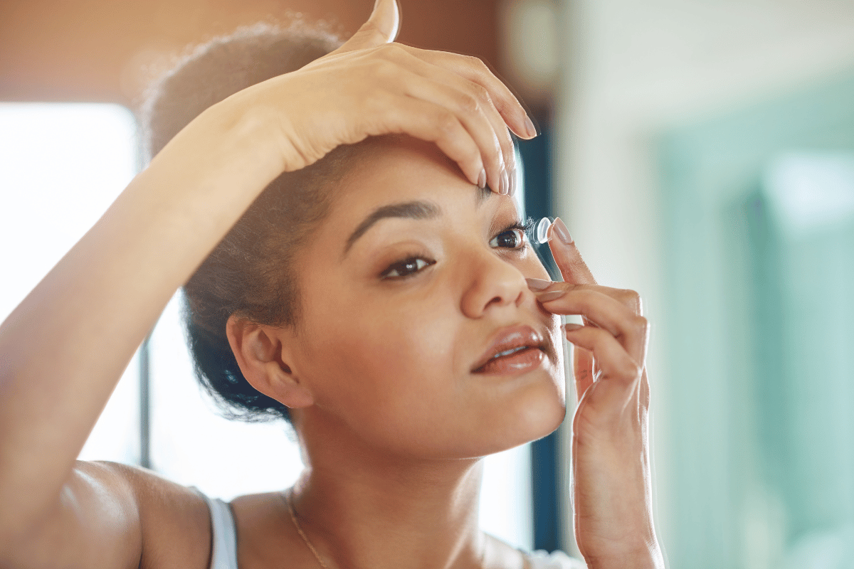 a woman putting a contact lens in