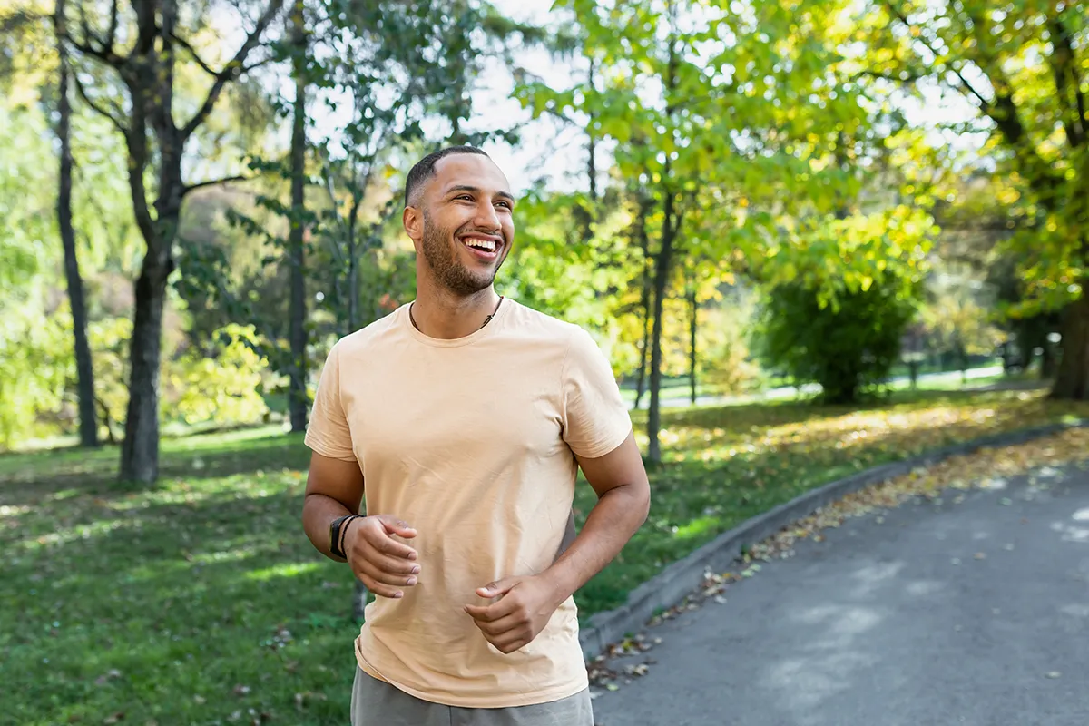 a man running outdoors in a park