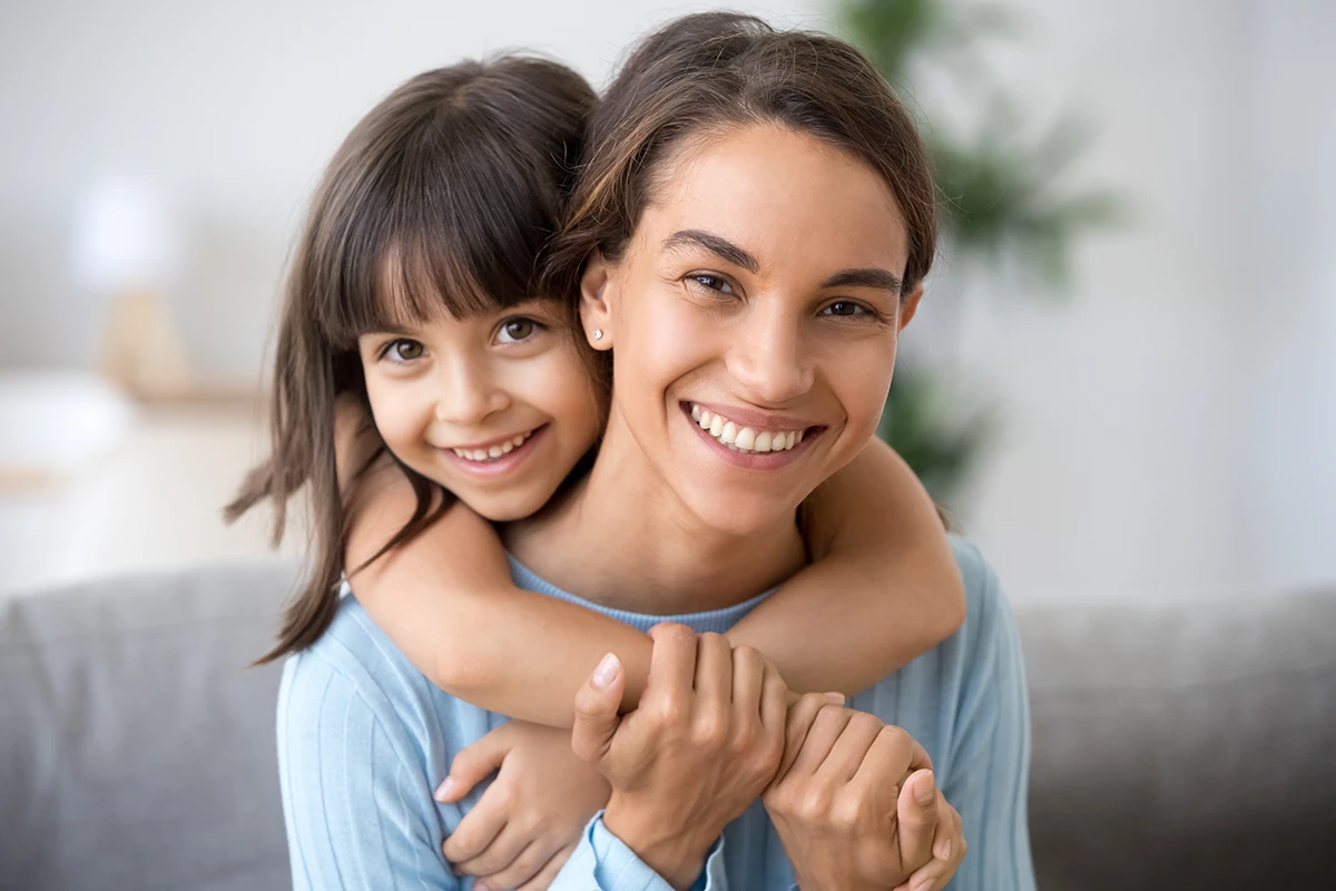 a little girl hugging her mom
