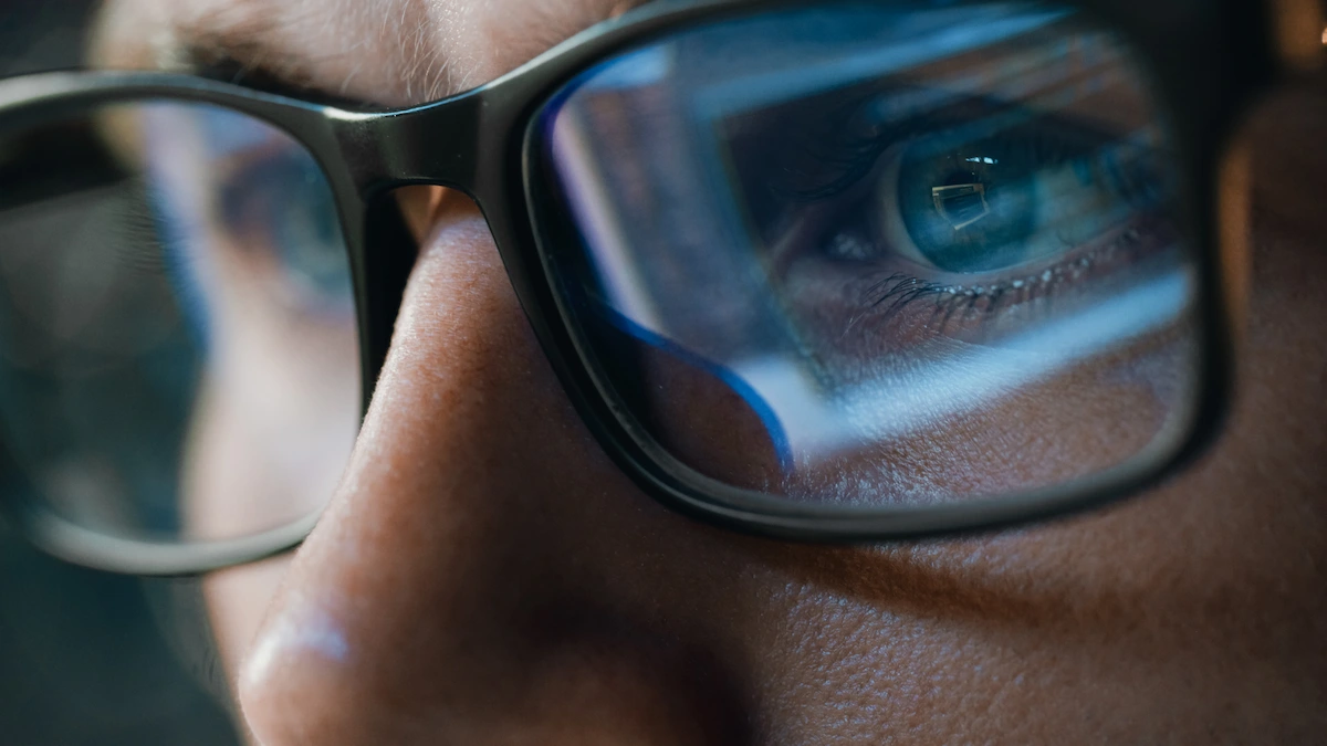 computer screen reflecting in glasses