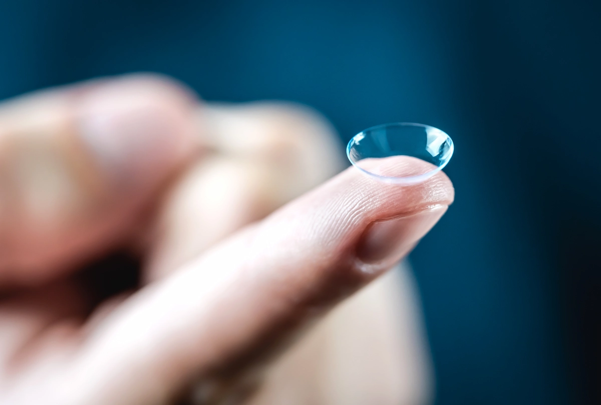 Close-up of contact lens placed on fingertip